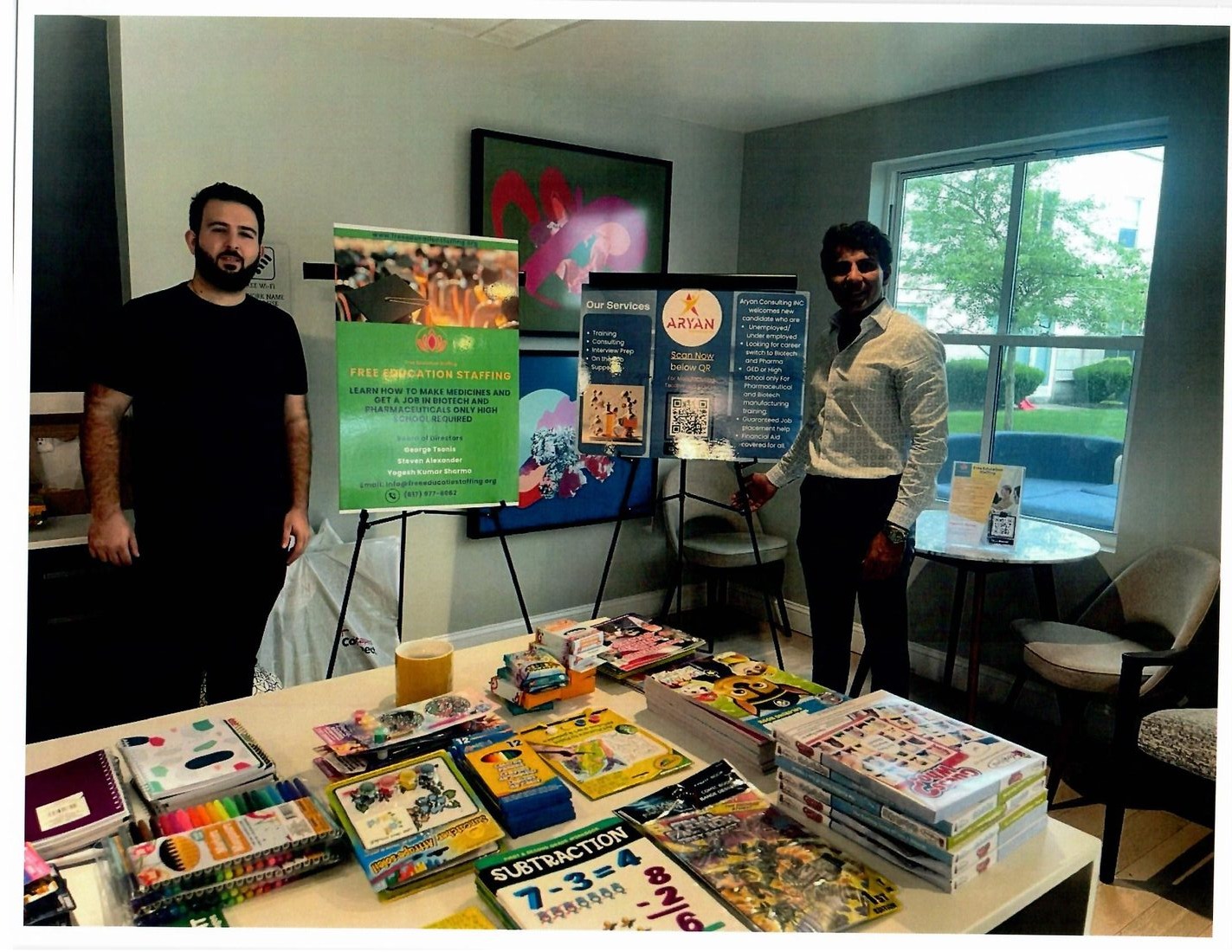 Community outreach table with Free Education Staffing poster